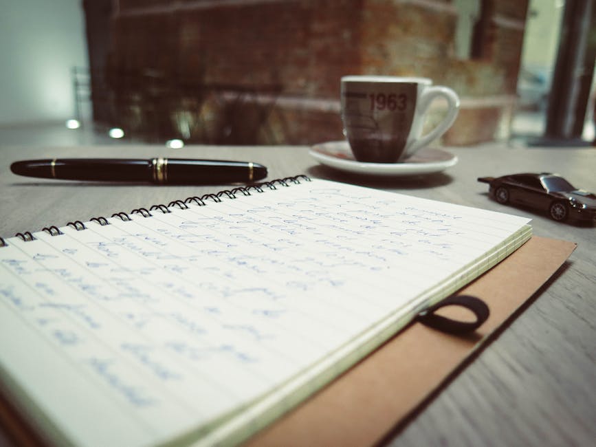 An open notebook and a coffee cup on a wooden desk - methodology reference