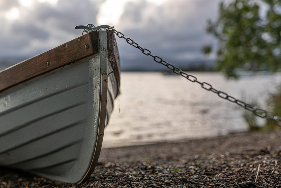A rowboat moored on Lake Windermere - the lake's shore at Ambleside